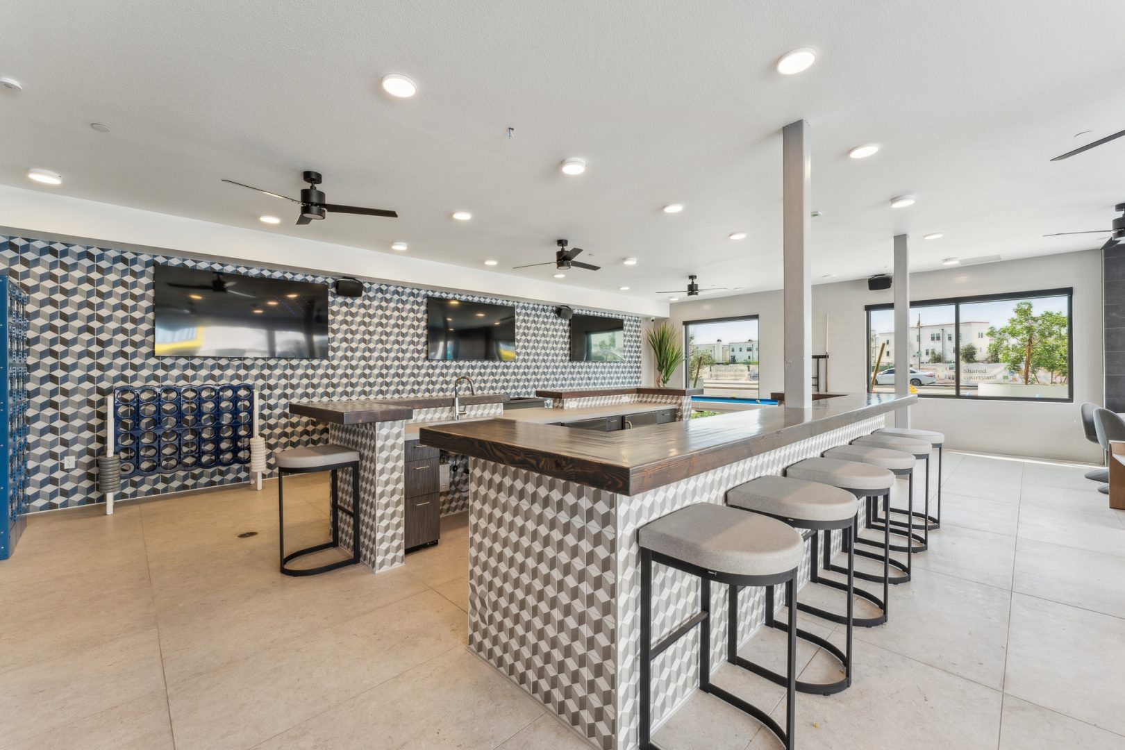 a kitchen with a bar and stools in a large room at The Blue Eastline