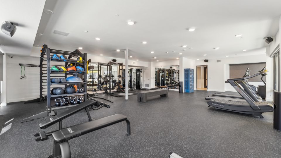 a gym room with exercise equipment and treads at The Blue Eastline